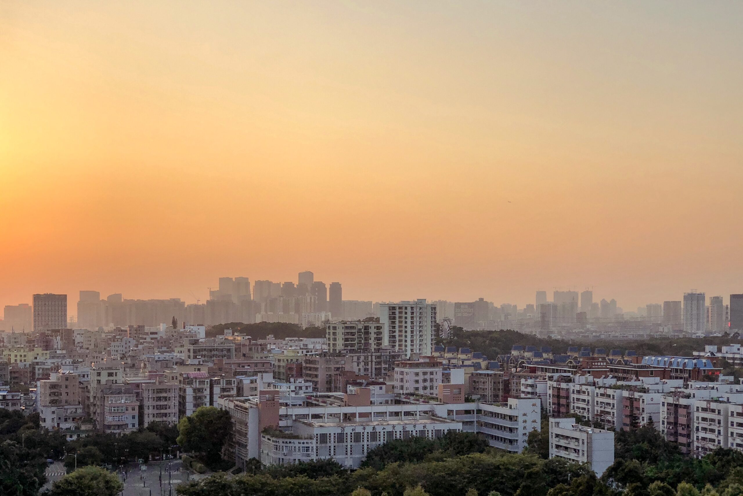service-1 beautiful panoramic shot of city buildings under an orange sky at sunset
